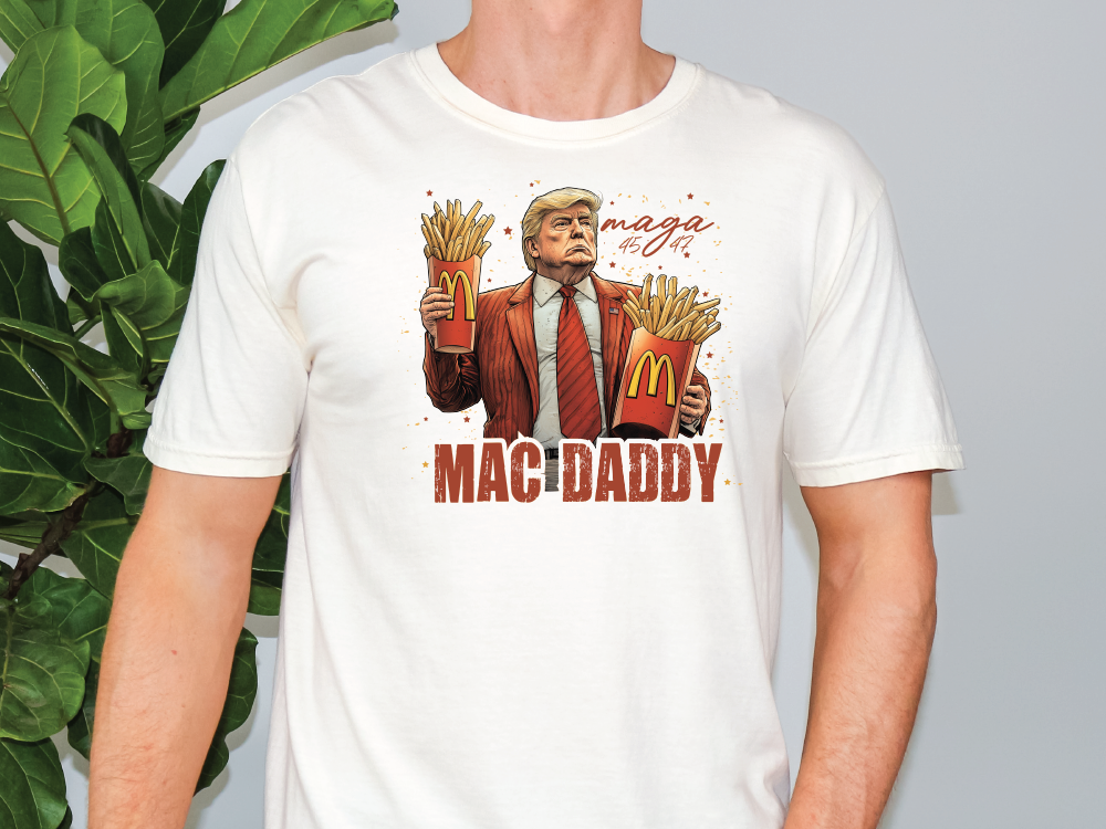 a man wearing a t - shirt with a picture of a man holding french fries