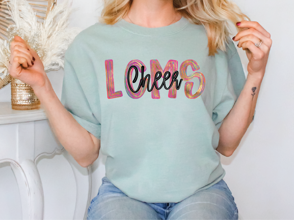 A woman wearing a light blue t-shirt with the word "LMS" printed on it.