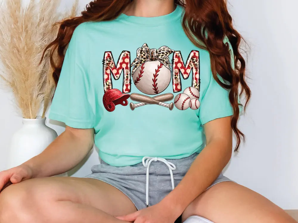 a woman wearing a mom t - shirt with a baseball on it