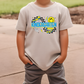 a young boy wearing a t - shirt with a smiley face on it