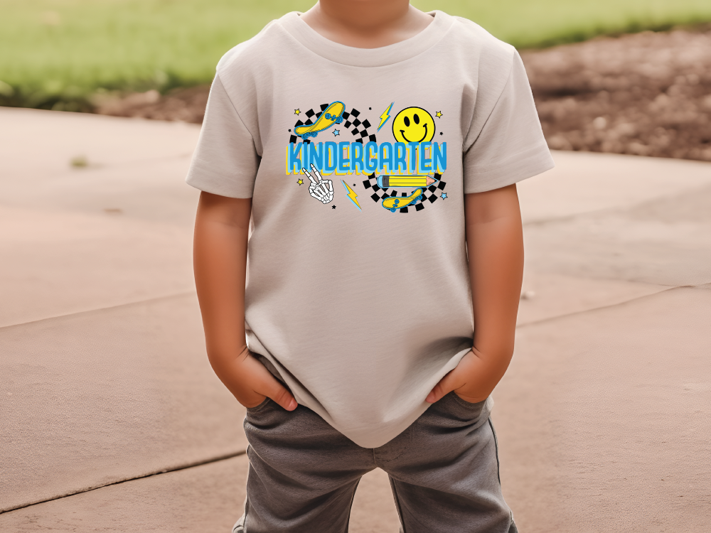 a young boy wearing a t - shirt with a smiley face on it