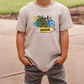 a young boy wearing a t - shirt with a cactus on it