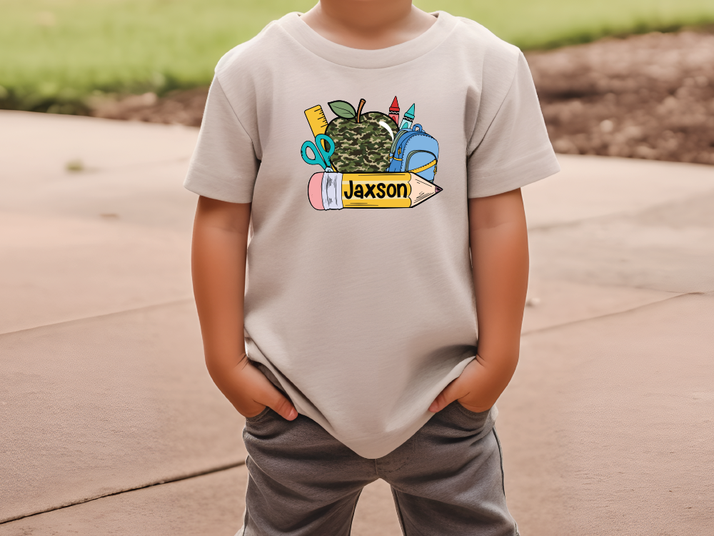 a young boy wearing a t - shirt with a cactus on it