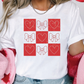 a woman wearing a t - shirt with hearts on it