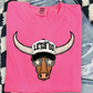 A pink t-shirt with a cartoon bull wearing sunglasses and a hat with the text "LET'S GO" printed on it.