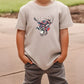 a young boy wearing a t - shirt with a deer head on it