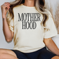 a woman wearing a t - shirt that says motherhood