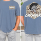 a man wearing a blue t-shirt with a graphic design on the back. The design features a helmet with a plume and the word "CRUSADERS" written above it.
