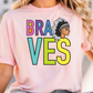 A woman wearing a pink t-shirt with the text "Braves" printed on it.