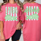 two women wearing pink t-shirts with a graphic design featuring a green alligator and the text "later after while" printed on them.