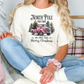 a woman sitting on a couch wearing a t - shirt with a christmas tree on