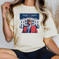 a woman wearing a trump parody t - shirt