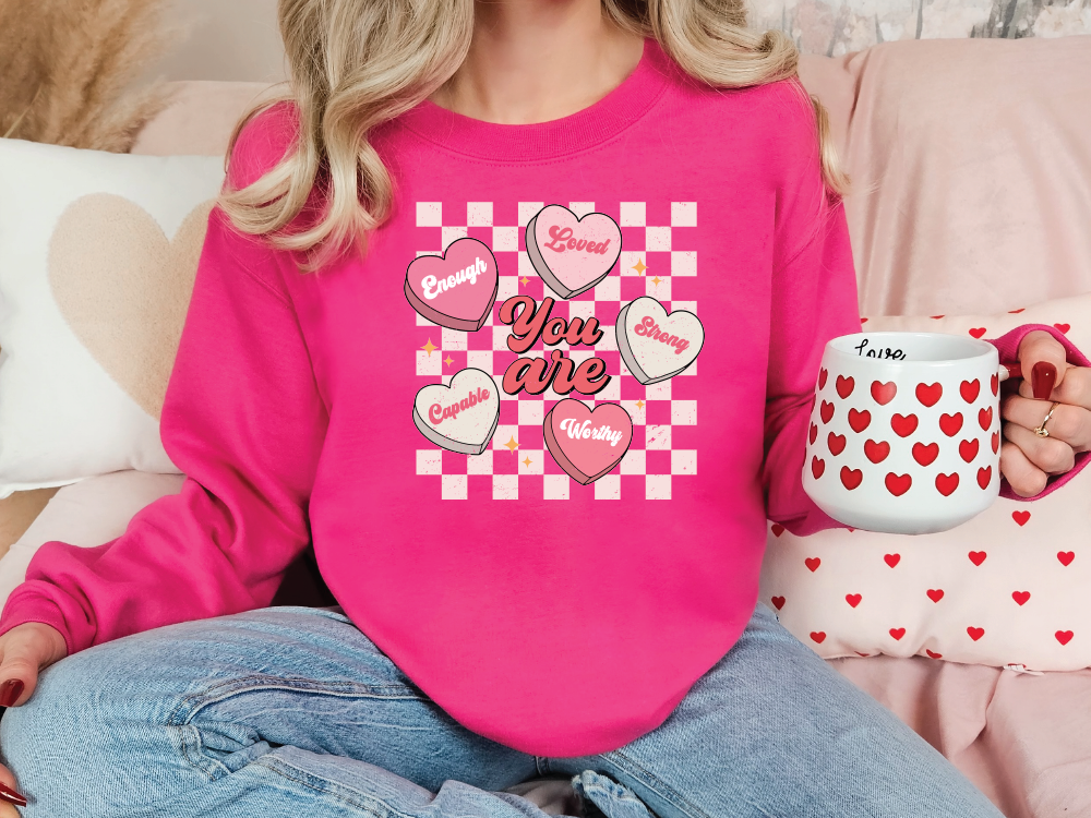 a woman sitting on a bed holding a coffee mug