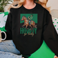 a woman sitting on a couch wearing a black sweatshirt with a picture of a horse