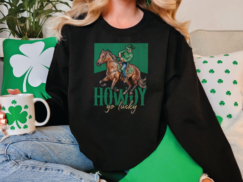 a woman sitting on a couch wearing a black sweatshirt with a picture of a horse