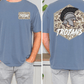 A man wearing a blue t-shirt with a graphic of a helmet and the word "TROANS" printed on it.