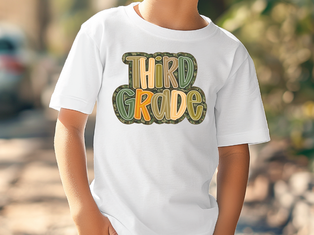a young boy wearing a white shirt that says third grade