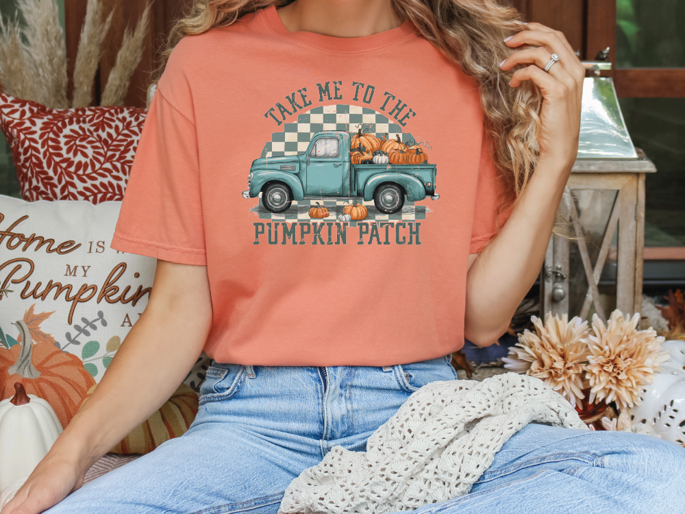 a woman sitting on a couch wearing a pumpkin patch shirt