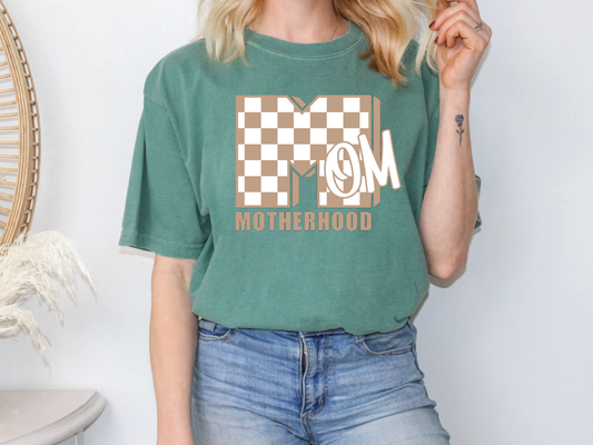a woman wearing a mom shirt and smoking a cigarette