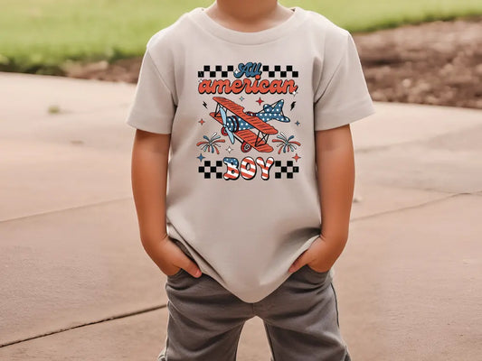 a young boy wearing a t - shirt with an airplane on it