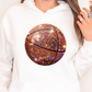 a woman wearing a white hoodie with a basketball on it