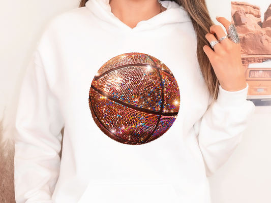 a woman wearing a white hoodie with a basketball on it