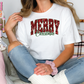 a woman sitting on a bed wearing a merry christmas shirt