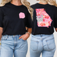 two women wearing black tshirts with pink and white designs on them