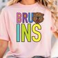 A woman wearing a pink t-shirt with the word "BRUINS" printed on it, featuring a graphic of a bear's head.