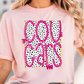 A woman wearing a pink t-shirt with the word "COUGARS" printed on it in a bold, pink font with black polka dots.