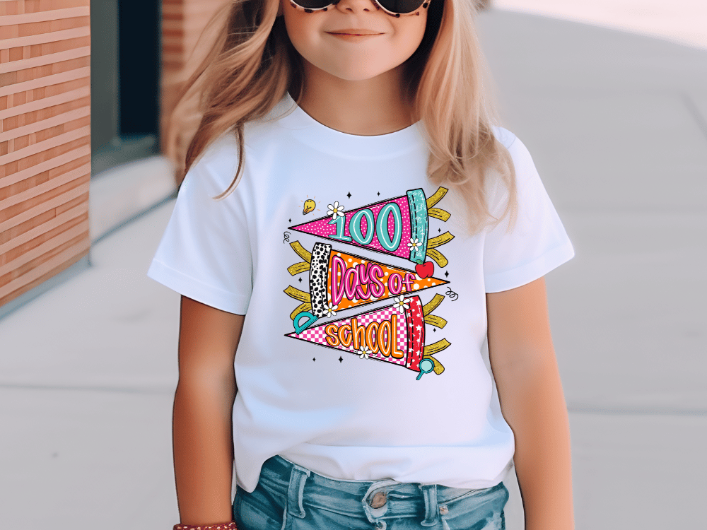 A young girl wearing a white t-shirt with a colorful graphic design and text printed on it.