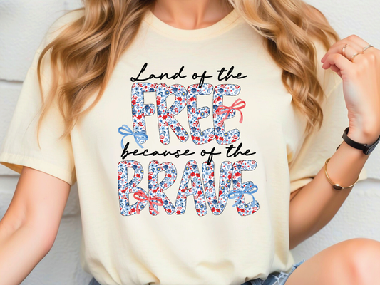 a woman wearing a t - shirt that says land of the free because of the