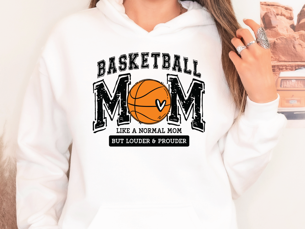 a woman wearing a white hoodie with a basketball mom on it