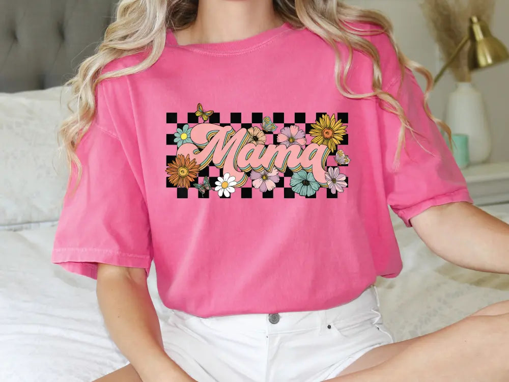 a woman sitting on a bed wearing a pink shirt