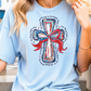 a woman wearing a blue t - shirt with a cross on it