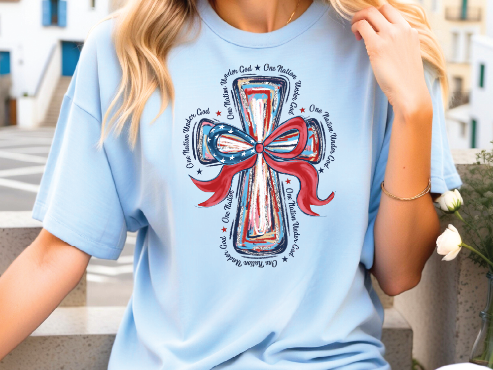 a woman wearing a blue t - shirt with a cross on it