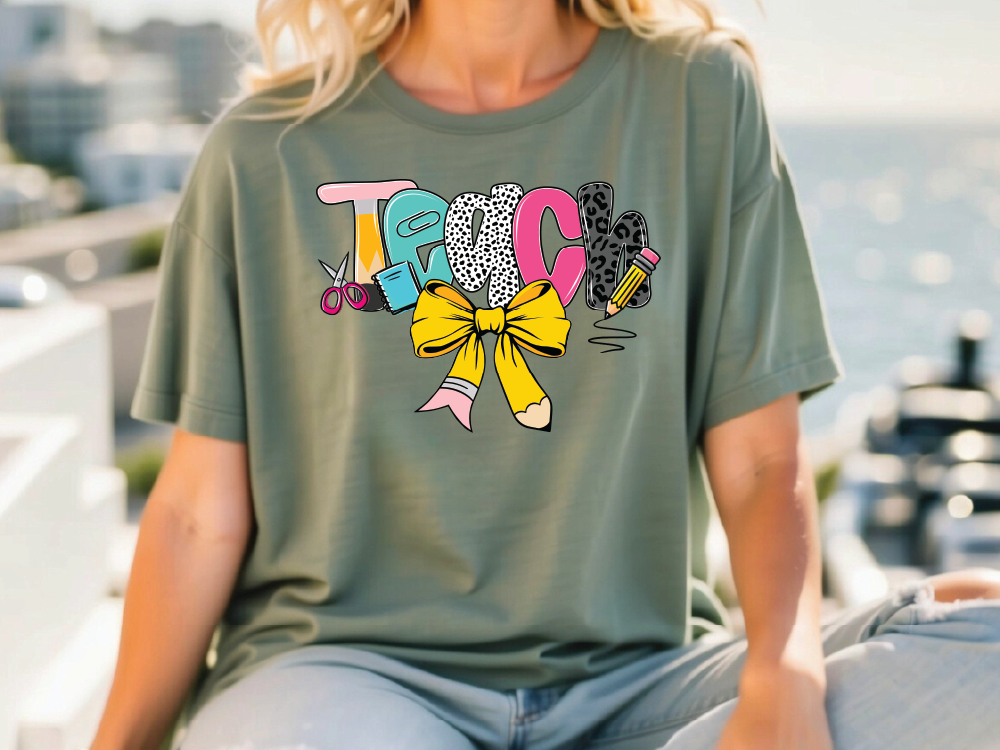 a woman wearing a tshirt with a bow sitting on a bench