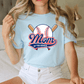 A woman wearing a light blue t-shirt with a baseball graphic and the text "Mom of the Rookie" printed on it.