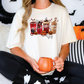 a woman sitting on a bed holding a pumpkin mug