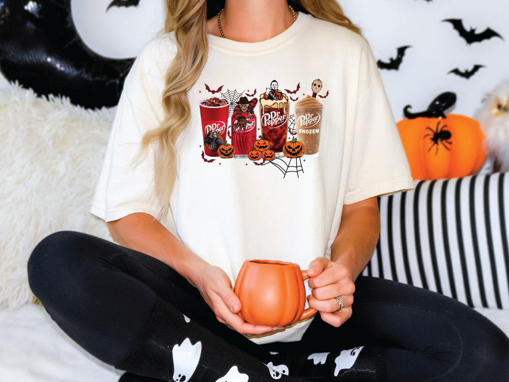 a woman sitting on a bed holding a pumpkin mug