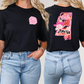 two women wearing black tshirts with pink flowers on them