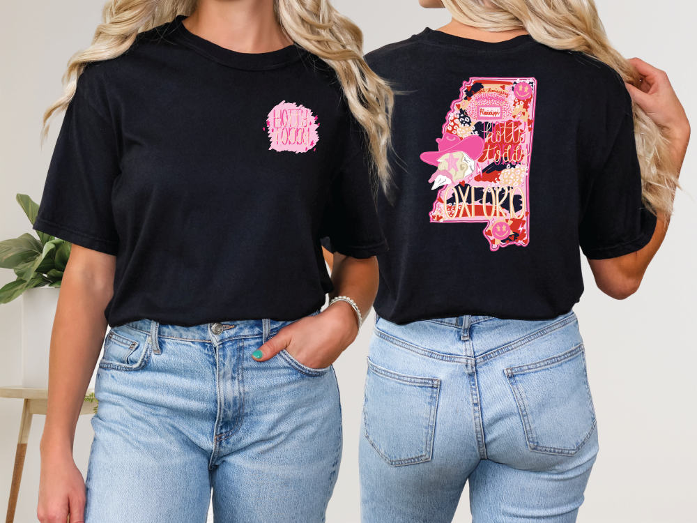 two women wearing black tshirts with pink flowers on them