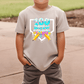 A child wearing a t-shirt with a colorful graphic design featuring a dripping, dripping, dripping pattern and the text "100 days of school".