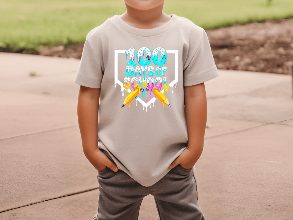 A child wearing a t-shirt with a colorful graphic design featuring a dripping, dripping, dripping pattern and the text "100 days of school".
