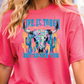a woman wearing a pink shirt with a bull's head on it