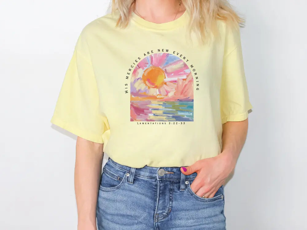 a woman wearing a yellow shirt with a painting on it