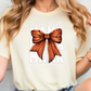 a woman wearing a t - shirt with a bow on it