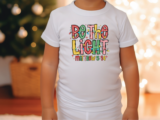 a little girl wearing a white shirt that says both the light matters