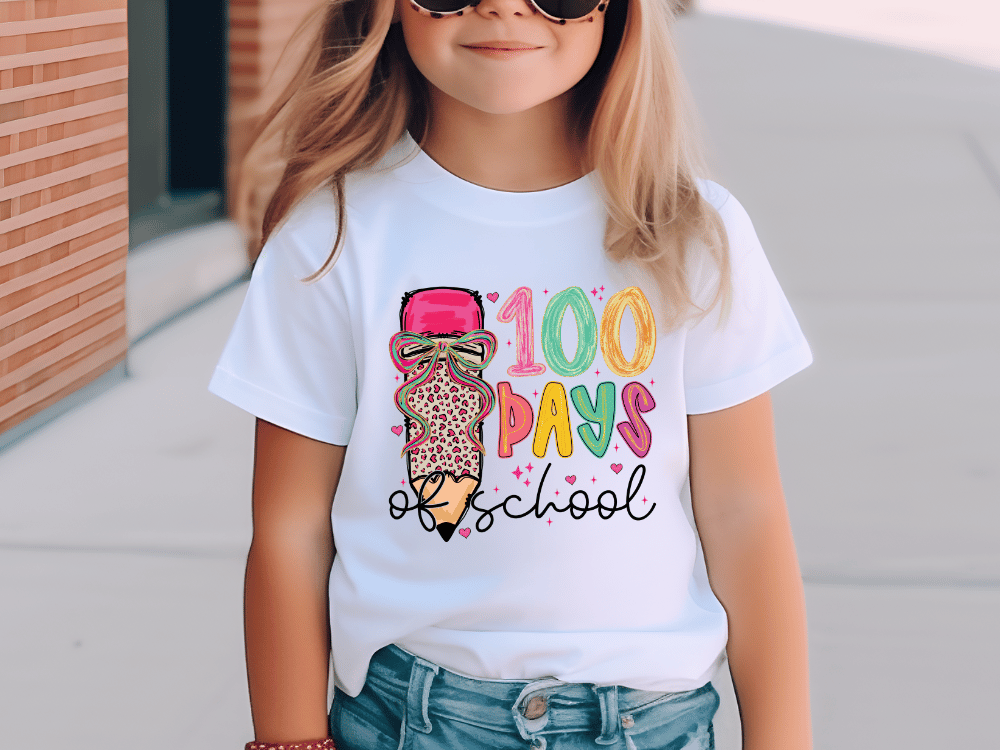 A young girl wearing a white t-shirt with a colorful graphic design and text printed on it.