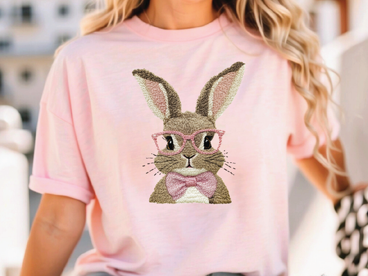 a woman wearing a pink shirt with a bunny wearing glasses